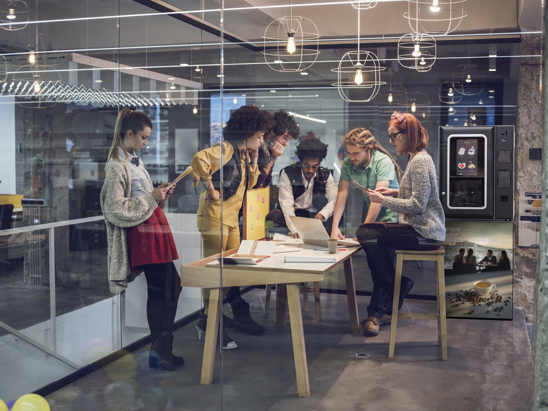 A team working beside a Necta Barista 300 Touch countertop coffee machine