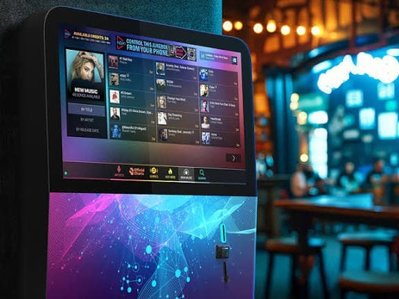 NSM digital Jukebox on a pub wall with phone control
