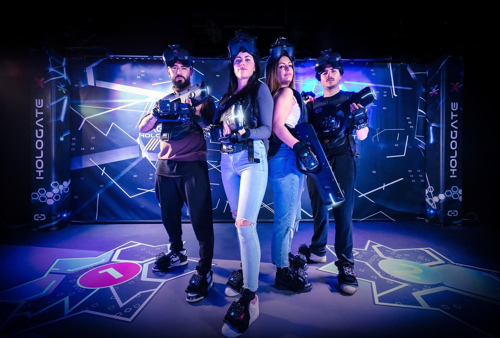 Squad of players in VR headsets and haptic vests