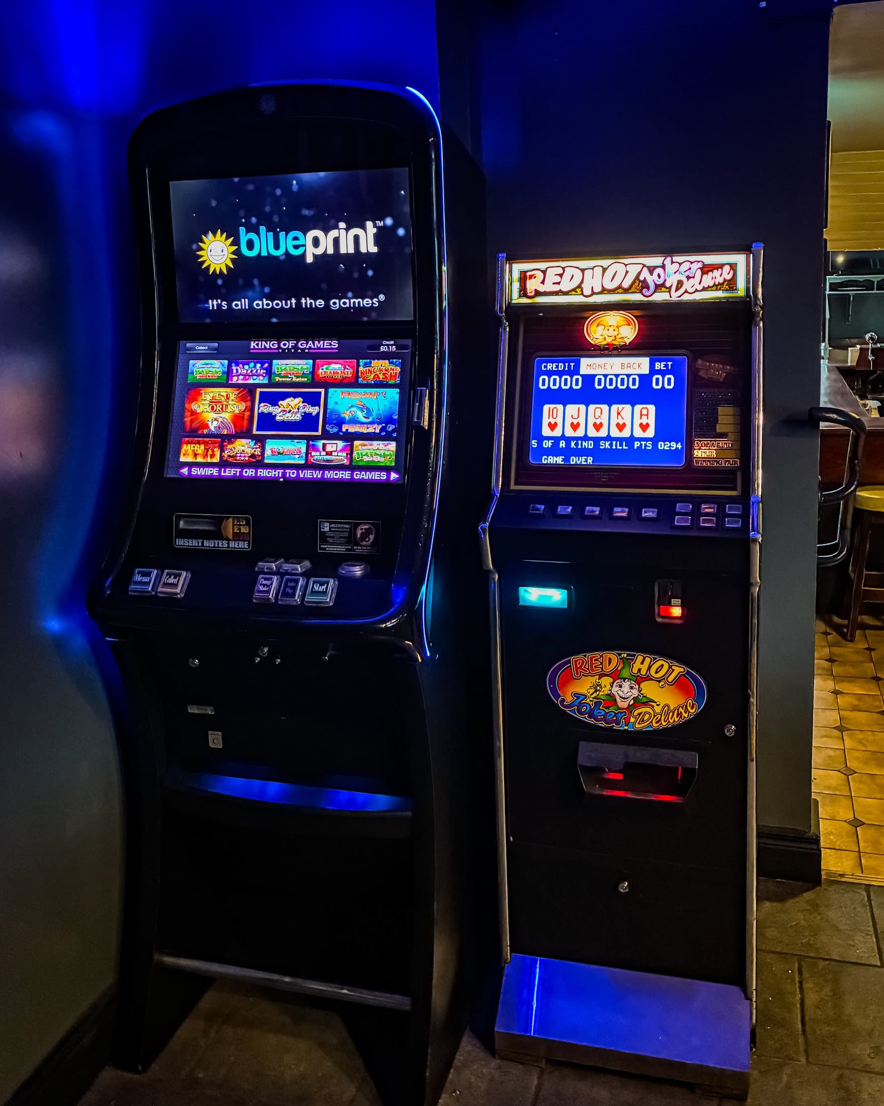 Red Hot Joker Deluxe Poker Machine on a venue wall